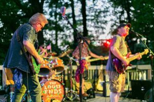 A rock band plays for the crowd at a course event.