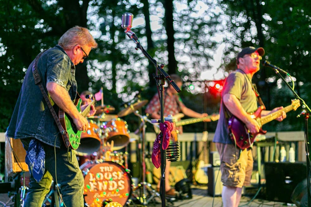 A rock band plays for the crowd at a course event.