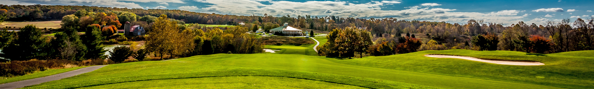 Panoramic view of Little Bennett Golf Course with rolling green hills and autumn foliage.